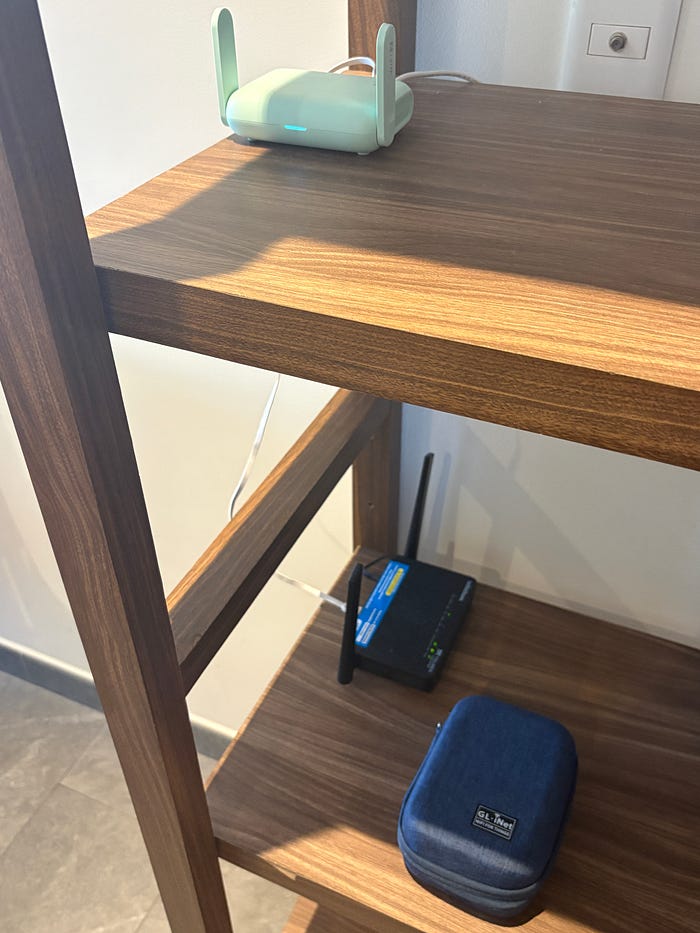 Airbnb router LAN port connected to GL.iNet router WAN port and laptop
